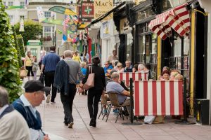 people walking along footpath on main street