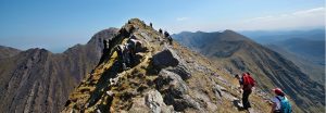 Destination Killarney - People hiking to the top of a mountain